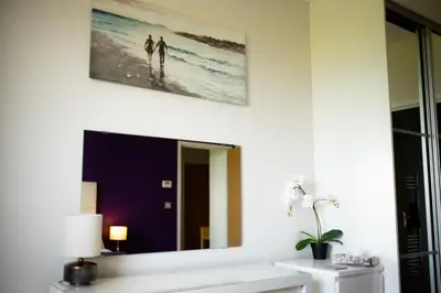 a mirror on a wall above a sink in a bathroom at Stunning Sea Views, luxury apartment beaches & restaurants are a short walk away in Newquay
