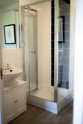 a bathroom with a shower and a sink at Stunning Sea Views, luxury apartment beaches & restaurants are a short walk away in Newquay