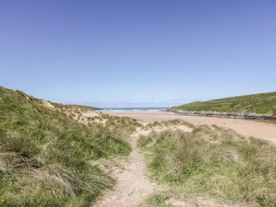 a dirt path leading to the beach at The Sand Dunes in Crantock