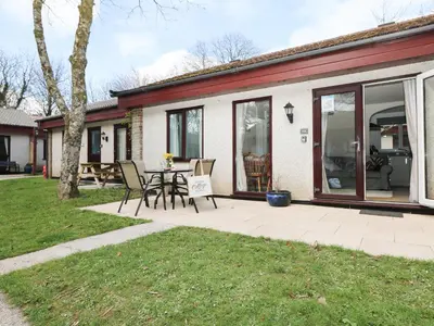 a patio with a table and chairs in a yard at Miles Retreat in Hayle