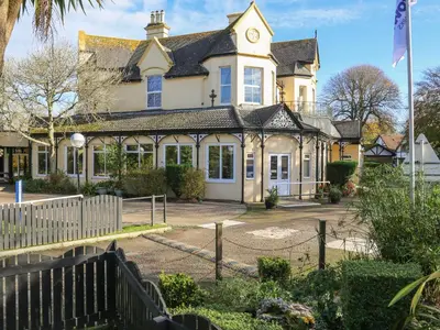 a house with a fence in front of it at Miles Retreat in Hayle