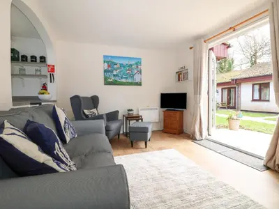 a living room with a couch and a tv at Miles Retreat in Hayle