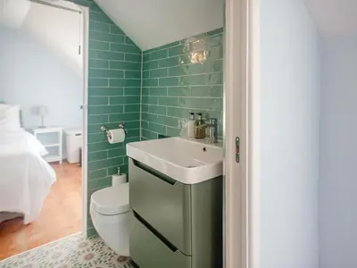 a bathroom with a sink and a toilet at Little Trevarrack in Carbis Bay