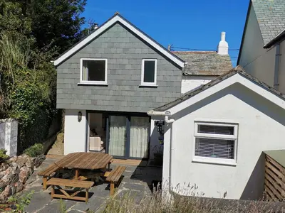 a house with a table and a picnic table outside at Hawthorn Cottage in Bodmin
