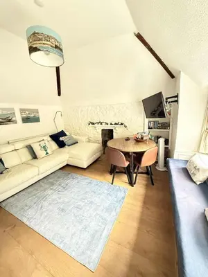 a living room with a couch and a table at The Nest - St Ives in St Ives