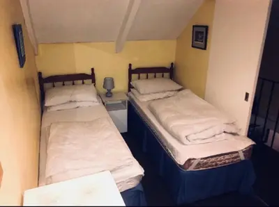 two twin beds in a small room with at Cottage in village of Mevagissey Cornwall Sleeps 4 in Mevagissey