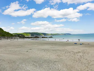 a group of people walking on a beach at Bay Tree Cottage in Looe