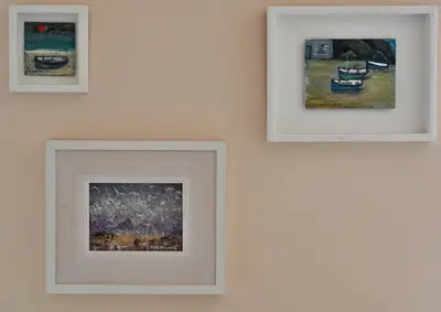 three framed paintings hanging on a wall at Halwell Lodge in St Ives