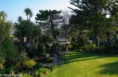 a gazebo in the middle of a garden at Halwell Lodge in St Ives