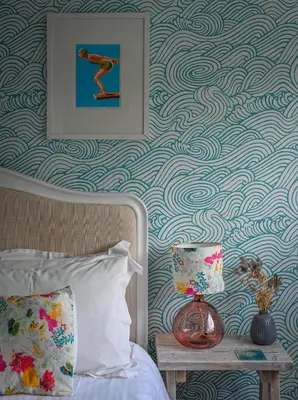 a bedroom with a blue and white patterned wall at Halwell Lodge in St Ives
