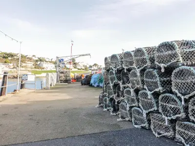 a pile of chain link fencing in a parking lot at Puffin Cottage in Truro