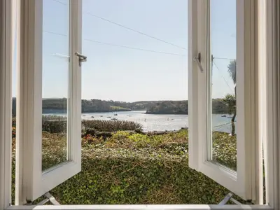 an open window with a view of the water at Puffin Cottage in Truro