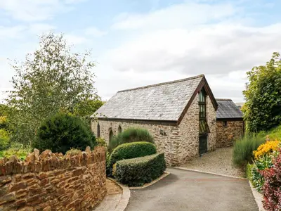an old stone house with a stone wall at Frogwell Chapel in Callington