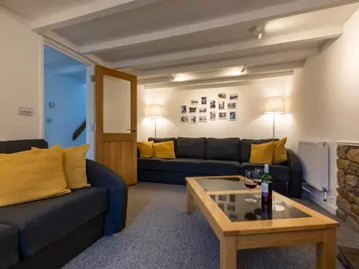 a living room with two couches and a coffee table at Rose Cottage in St Ives