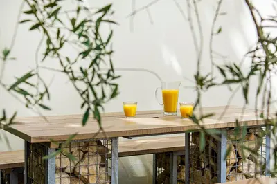 two glasses of orange juice on a wooden table at Tall Ships, Charlestown - two ticks from the harbour in Charlestown
