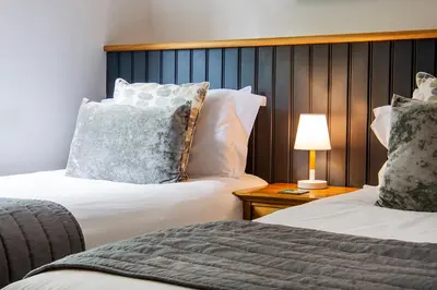 a hotel room with two beds and a table with a lamp at Tall Ships, Charlestown - two ticks from the harbour in Charlestown