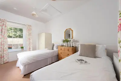a bedroom with two beds and a window at Stable House in Redruth