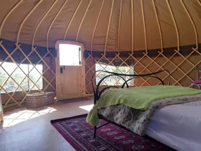 a bedroom with a bed in a yurt at Looe Yurts in Looe