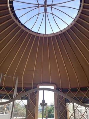 a large yurt roof with a circular window at Looe Yurts in Looe