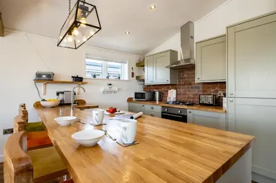 a kitchen with a wooden counter top in a room at Edge of Padstow, 2 bedroom luxury lodge in Padstow