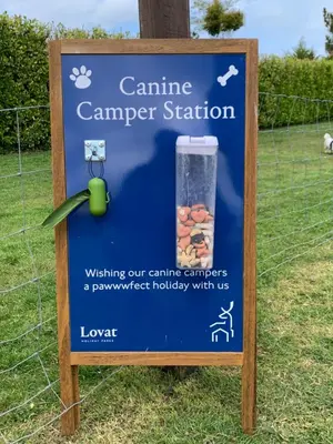 a sign for a camping camera station in a field at Edge of Padstow, 2 bedroom luxury lodge in Padstow