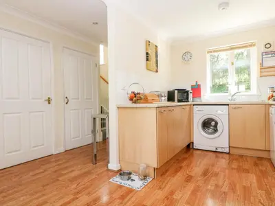 a kitchen with a washer and dryer in a house at Robinswood in Falmouth