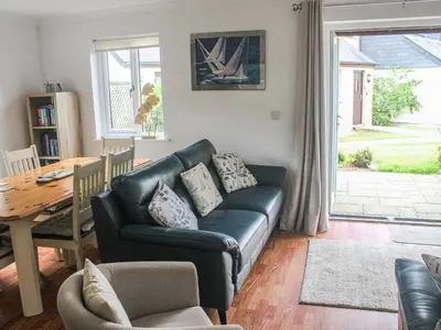 a living room with a couch and a table at Robinswood in Falmouth