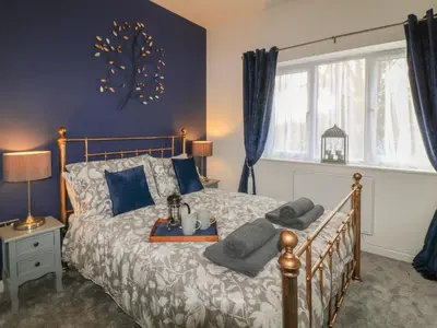 a bedroom with a bed with a tray on it at Primrose End in Bude