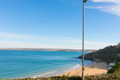 a view of a beach with a street light at 11 Carrack Widden in St Ives