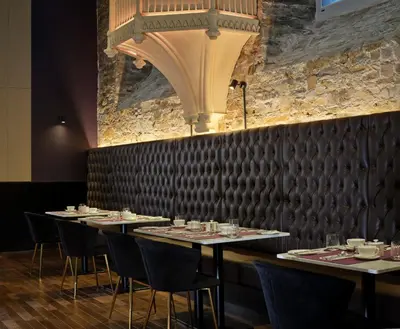 a row of tables in a restaurant with chairs at Bodmin Jail Hotel in Bodmin