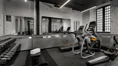 a gym with treadmills and ellipticals in a room at Bodmin Jail Hotel in Bodmin