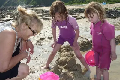 two girls playing in the sand on the beach at Rostowan Villa, very near the Beach in Truro