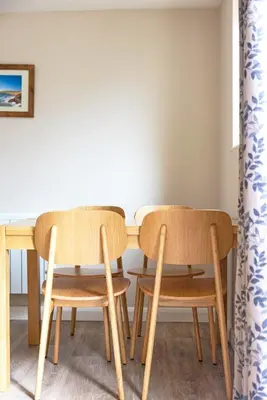 two chairs and a table in a room at Gwithian Holidays in Hayle