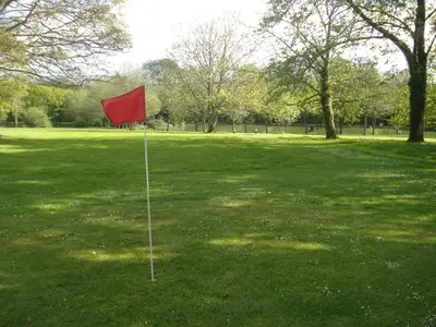 a red flag in the middle of a grass field at Detached Bungalow in North Cornwall in Bodmin