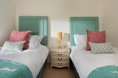 two beds sitting next to each other in a bedroom at Navas Nook in Falmouth