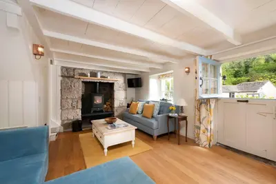 a living room with a couch and a fireplace at Navas Nook in Falmouth