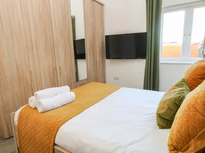 a bedroom with a large bed with towels on it at Woodhall in Bodmin