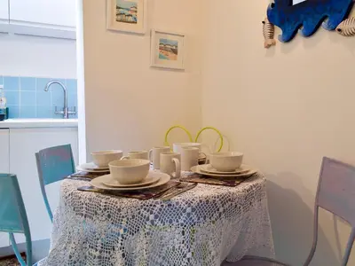 a table with cups and saucers on it at The Cottage in St Ives