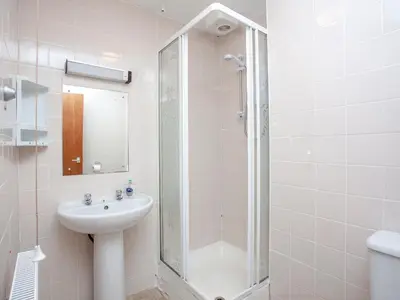 a white bathroom with a sink and a shower at 117 Atlantic Reach-Uk32918 in Saint Columb Major