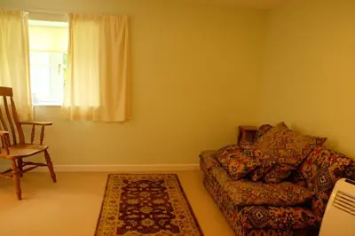 a living room with a couch and a window at Okewoon Barn in Lanivet