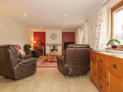 a living room with two chairs and a table at Meadowside in Truro