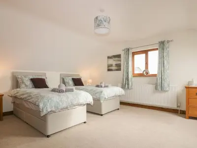 a bedroom with two beds and a window at Meadowside in Truro
