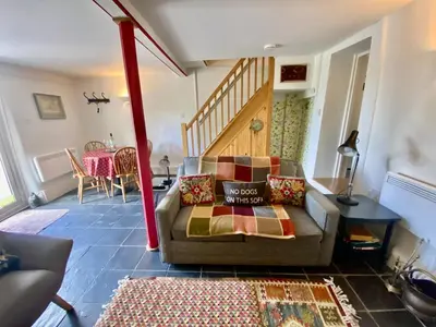 a living room with a couch and a table at Frogmore Corner in Tregoney