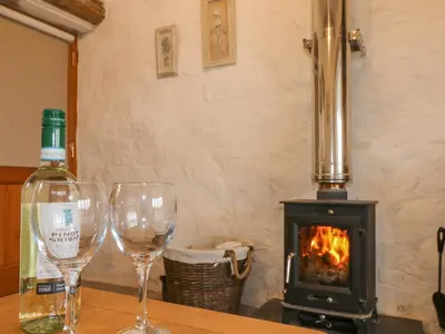 two wine glasses sitting on a table next to a stove at Edwin's View in Helston