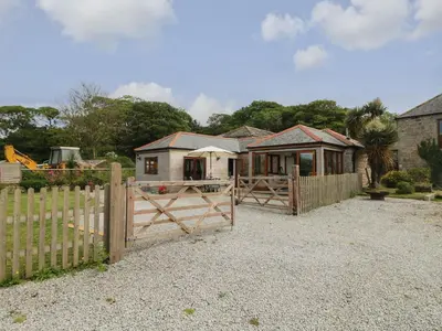 a house with a wooden gate and a fence at Edwin's View in Helston