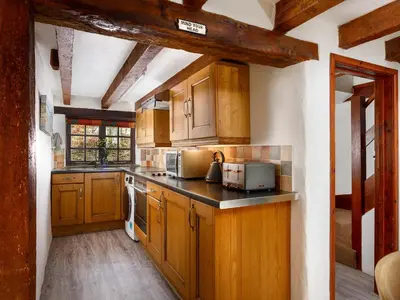 a kitchen with wooden cabinets and a counter top at Little Leighs in Launceston