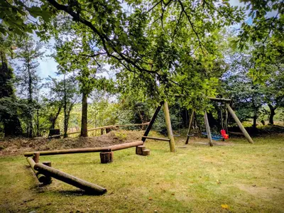 a park with a swing set in the grass at Pond Meadow in Launceston