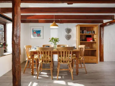 a dining room with a wooden table and chairs at Pond Meadow in Launceston