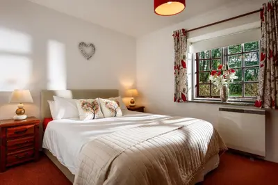 a bedroom with a white bed and a window at The Roundhouse in Launceston