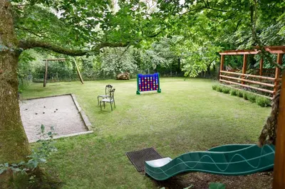 a yard with a playground with a swing set at The Roundhouse in Launceston